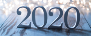 2021 in numbers on floorboards with christmas light in the background