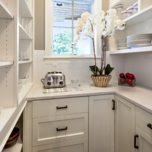 Butler's Pantry with white cabinets and white benchtop with toaster and utensils stored ontop