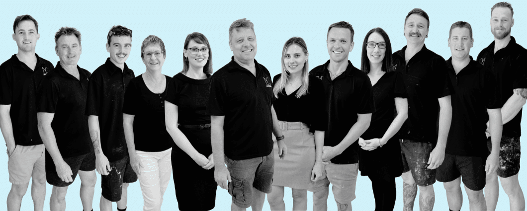 Nyblad Construction team photo in greyscale on nc blue background